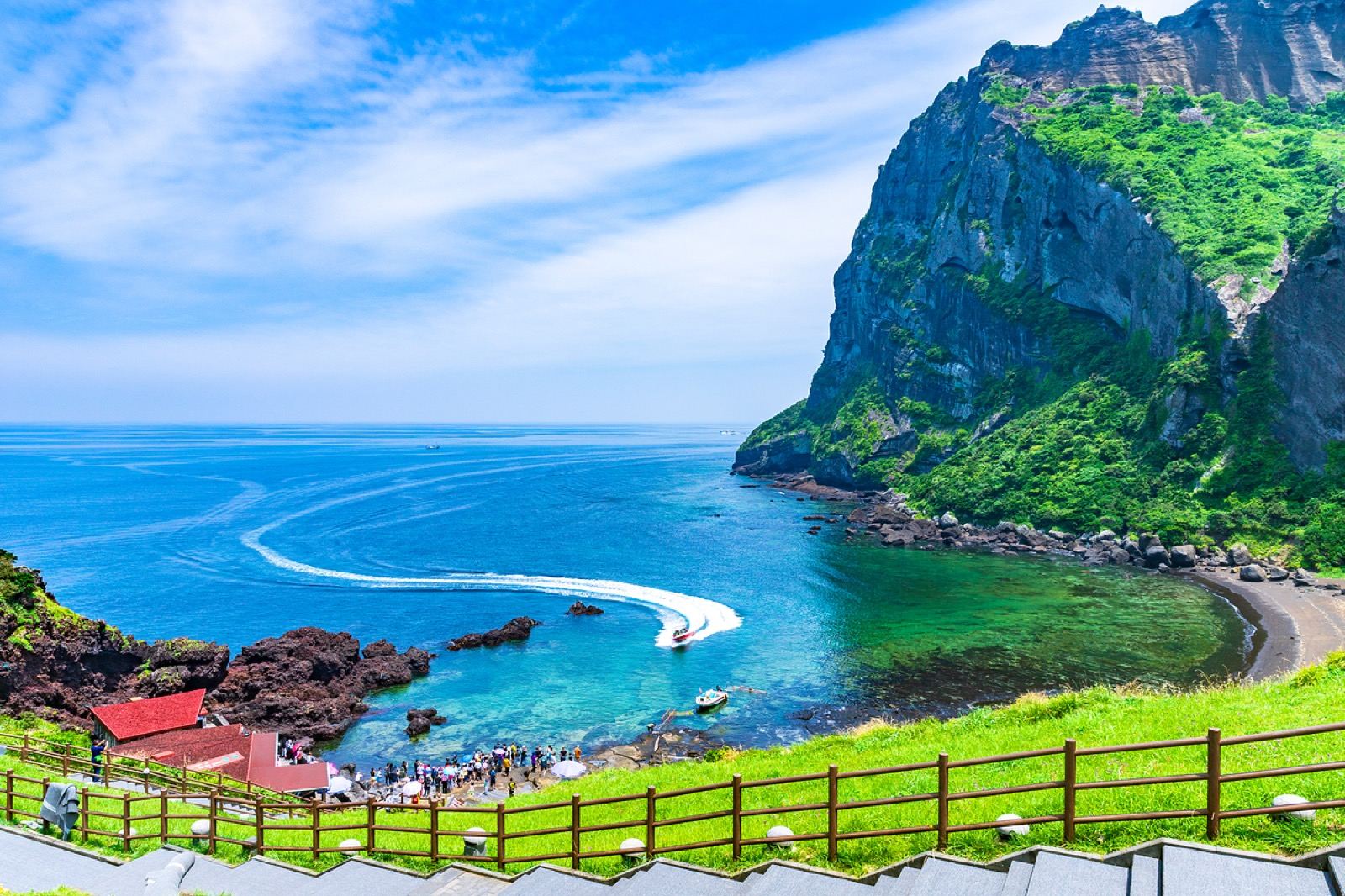 Seongsan Ilchulbong, a green volcanic tuff cone rising from the sea on Jeju's east coast