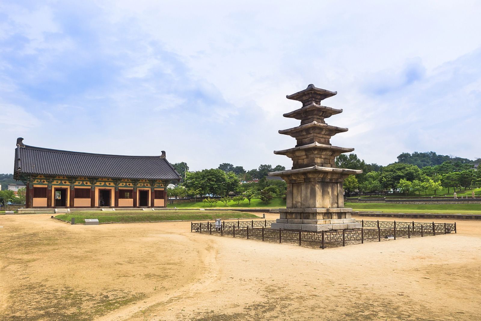 The five-story stone pagoda at the Jeongnimsa temple site in Buyeo, with a traditional hall behind it