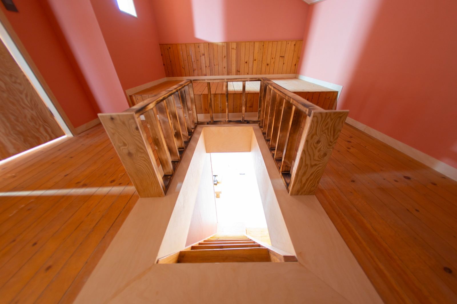 The warm wood-and-clay interior of a Korean jjimjilbang common room with a raised resting floor